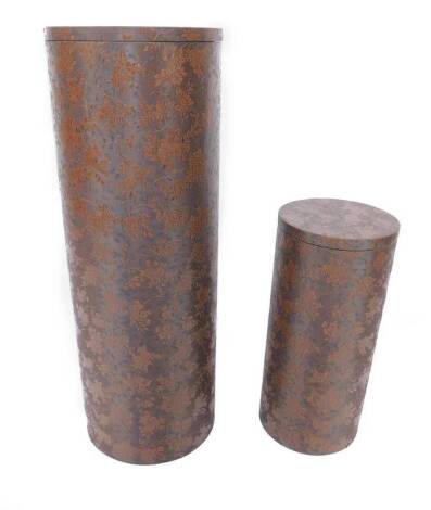 *Two graduated cylindrical storage boxes, decorated in floral and berry tooled faux leather, largest box 100cm H, 36cm W, 36cm D.