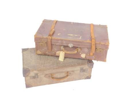 A leather suitcase, bears traces of luggage labels and a further canvas and leather bound suitcase, deposit label Case & Sons Salisbury. (2)