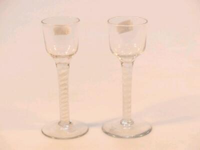 An 18thC wine glass with an oge? bowl over a double cotton twist stem and