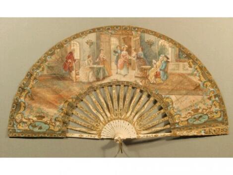 An 19thC hand painted fan depicting figures in an interior scene and signed