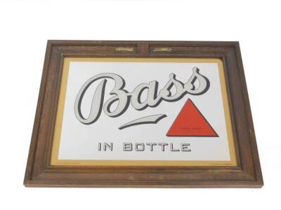 A Bass advertising wall mirror, Bass in bottle, in an oak frame with By Appointment Brewers to The King, and the Royal Coat of Arms, the glass stamped Property of Bass, Ratcliff and Cretton Limited, O C Hawkes Limited, Birmingham, 74cm H, 94.5cm W.