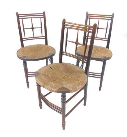 A set of three late 19thC oak bentwood chairs, with oval rush seats, raised on turned legs united by stretchers.