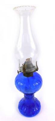 A Continental blue glass oil lamp, with a clear glass chimney, 38cm H.