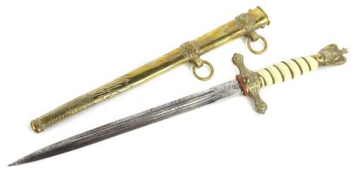 A German Third Reich naval dagger, with engraved brass scabbard, the blade stamped WKC with a stylised Roman soldier, ivorine handle with eagle pommel, 42cm L. Provenance: Brought back from Germany subsequent to the second world war by the vendors late fa