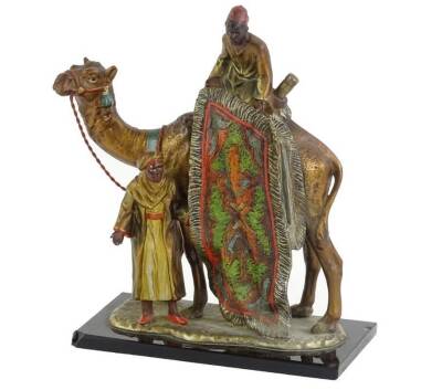 A Bergman type cold painted spelter figure group, depicting a carpet seller with a camel etc., on a black opaque glass base, 19cm H.