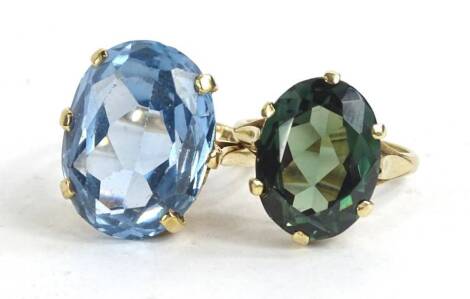 Two 9ct gold stone set dress rings, one set with aquamarine, the other set with green stone, each in claw setting on plain bands, 13.3g all in.