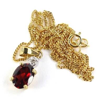 A 9ct gold pendant and chain, the pendant set with red/orange coloured stone, in claw setting with tiny diamond to top, on a fine link 9ct gold chain, 1.8g all in.