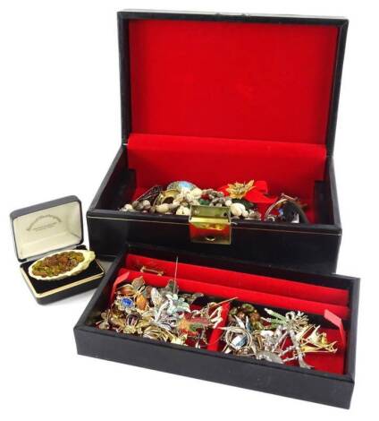 A black leatherette jewellery box and contents, including mainly decorative costume brooches of enamel type design, including butterfly, flowers, Canadian maple leaves, bagpipes, shell necklace etc. (1 box)