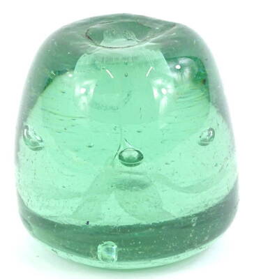 A Nailsea glass paperweight, with central flower and pot, surrounded by bubbles, 9cm H.