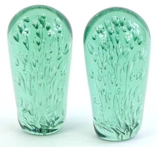 A pair of 19thC Nailsea green glass dumps, each with bubble decoration, 15cm H.