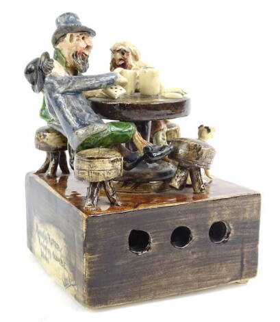 A Will Young Runnaford pottery musical figure group, depicting people playing cards with a dog etc., the musical movement playing the tune At Widdicombe Fair, 11cm W.