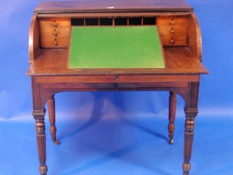 A late George III mahogany cylinder writing bureau with reeded and moulded top