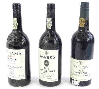 Three bottles of vintage port, Warre's 1975, Taylors 1977 and Grahams 1980.