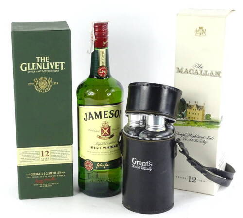Three bottles of whisky, Glenlivet 12 years, Macallan 12 years, a Grants spirit flask and bottle of Jamesons Irish Whisky.