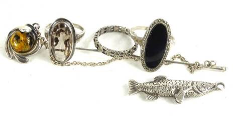 A small quantity of silver jewellery, to include a silver and imitation stick pin, and a silver fish pendant, a silver and marcasite eternity ring, a silver marcasite black agate dress ring, and a silver pale paste stone set dress ring. (5)