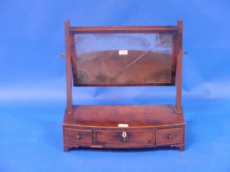 A George III flamed mahogany bow front dressing table mirror with rectangular