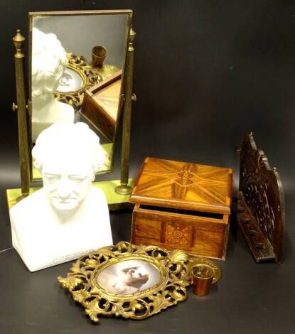 Miscellaneous items, to include a gilt brass dressing table mirror with simulated onyx base, a gilt metal frame, a parquetry box, a plaque stamped Rambler Boston, and a small measure, the base inset with a Victorian penny, a modern bust of Goethe and a pi