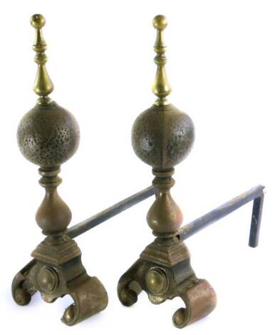 A pair of brass and iron fire dogs, each with a turned finial and shaped feet, 52cm H.