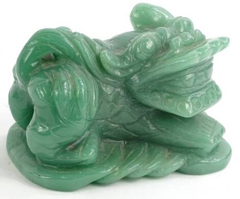 An oriental green hardstone carving, modelled in the form of a dog of fo or kylin, 9.5cm W.