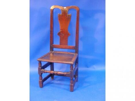 An early 18thC oak side chair of joined construction with solid splat and