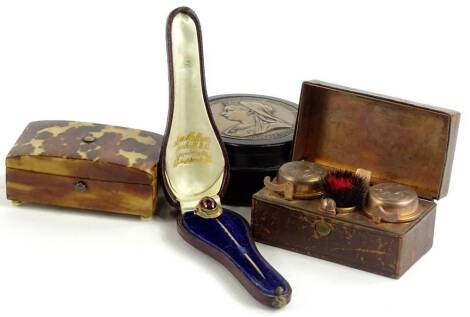 A collection of items, to include a Victorian tortoiseshell patch box, a Victorian Jubilee snuff box decorated to each end top and bottom with medallions, a travelling Victorian leather inkwell, and a yellow metal stick pin with oval red cabochon.