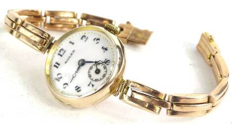 A ladies 9ct gold Rolex wristwatch, circa 1924, with white enamel dial, seconds dial blue hands, on later gold expanding strap, 20.8g.