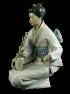 A large Nao porcelain figure of an oriental lady with a vase etc., 33cm H, boxed.