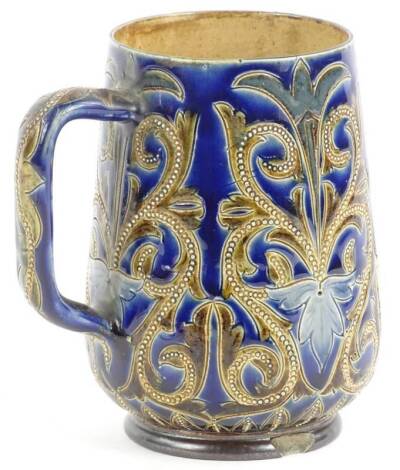 A Royal Doulton stoneware mug, decorated with scrolls and pearl type jewels, in brown on a cobalt blue ground, impressed mark to underside, decorators initials CAO, (AF), 13cm H.