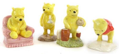 Four Royal Doulton Winnie the Pooh collection figures, to include Pooh lights the candle, Pooh counting the honey pots, Winnie the Pooh and the paw marks, and Winnie the Pooh in the arm chair.