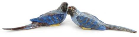 A pair of stoneware parrots, each with pale blue gilt and brown decoration, unmarked, 26cm L.