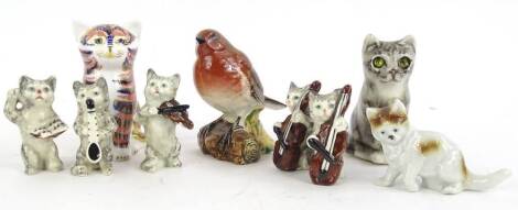 A collection of ceramic cats etc., to include a Royal Crown Derby Imari cat paperweight, a studio pottery Winstanley type cat, cats playing musical instruments, and a Beswick robin. (9)