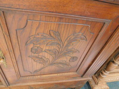 A French carved oak buffet, the top with two glazed doors, on turned supports, the base with two frieze drawers above two panelled doors on shaped feet, 125cm W. - 2