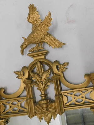 A giltwood and gesso wall mirror, in the style of Thomas Johnson, the crest decorated with an eagle, above a pierced floral and C 'scroll' decoration, 158cm x 73cm. - 2