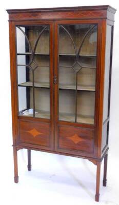 An Edwardian mahogany and marquetry display cabinet, the top with a moulded cornice above two part panelled part glazed doors, with panels below on square tapering legs, 167cm H, 91cm W.