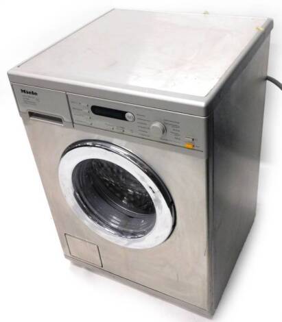 A Miele Honeycomb Care 5748 washing machine, with silvered and brushed steel effect case, 59cm W.