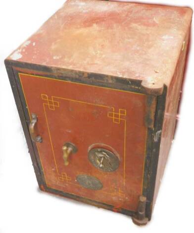 A small late 19th/early 20thC safe, painted in red and black, makers plaques, with key, 61cm H, 45cm W.