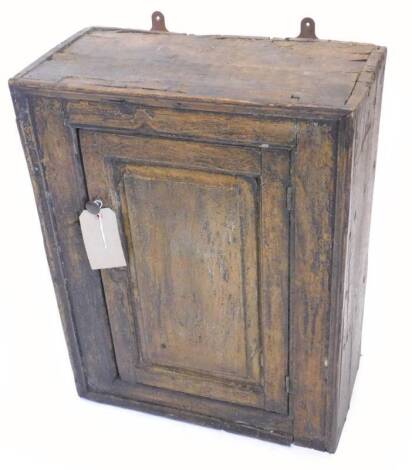 A late 18th/early 19thC pine small cupboard, with a single panelled door, 52cm W.