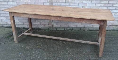 A 19thC pine four planked kitchen table, on plain supports with H stretcher, the top 80cm x 200cm.