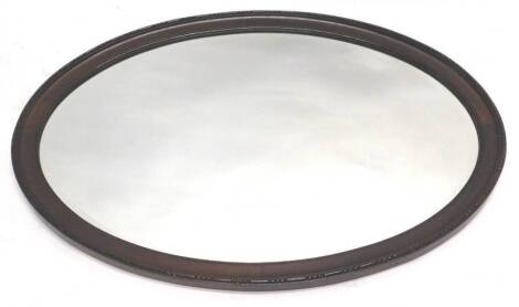 An early 20thC mahogany oval wall mirror, with a bevelled plate and a bead and reel border, 97cm W.