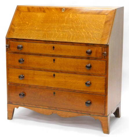 An early 19thC oak and mahogany crossbanded bureau, the fall enclosing a fitted interior above four graduated drawers each with turned wooden handles on bracket feet, 105cm W.