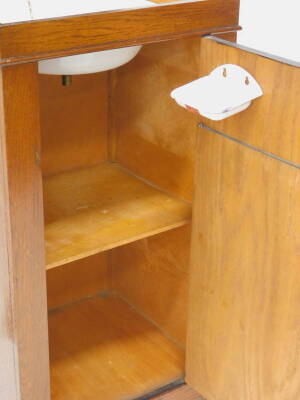 An oak wash stand cabinet, the hinged top enclosing a mirror and an enamel wash bowl with plug, etc., the door with further fitting enclosing a shelf, on bracket feet, 92cm H, 59cm diameter. - 3