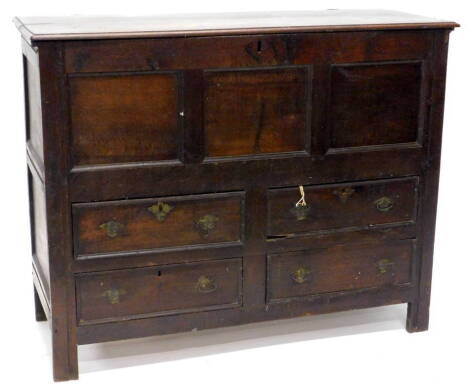 An early 18thC oak mule chest, the hinged top with a moulded edge, with a triple panelled front and an arrangement of four drawers on stiles, 103cm H, 128cm W, 53cm D.