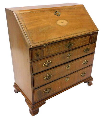 An Edwardian mahogany and chequer banded bureau, with four drawers on ogee bracket feet.