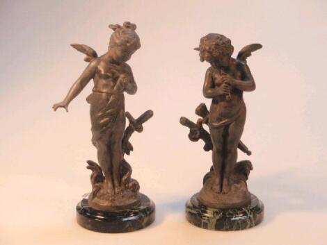 A pair of late 19thC French Spelter figures of two cherubs on green marble bases