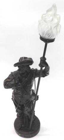 A bronzed figure lamp base, modelled in the form of a soldier holding a lantern with frosted shade, 107cm H.