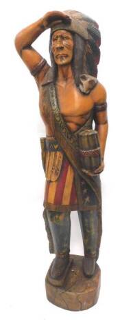 A carved wooden tobacco type figure of a Native American Indian, wearing stars and stripes, 98cm H.