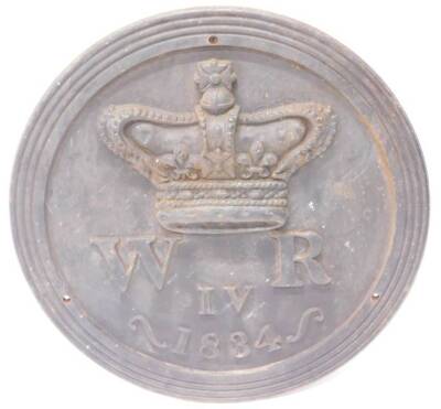 A large cast iron plaque, decorated with a crown and WRIV for William IV dated 1834, 74cm diameter. Provenance By repute removed from a large country house.