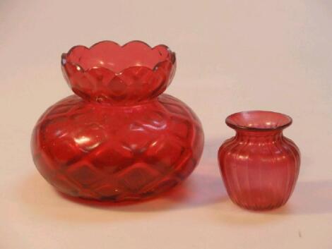 An early 20thC cranberry quilted glass vase