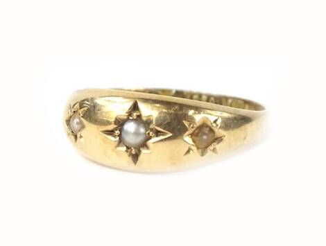 A Victorian 15ct gold gypsy set ring, set with three seed pearls in star design, 2.1g all in.