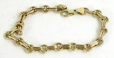 A 9ct gold ring and bar design bracelet, the rings with etched design each broken by two plain design bars, 5.5g.